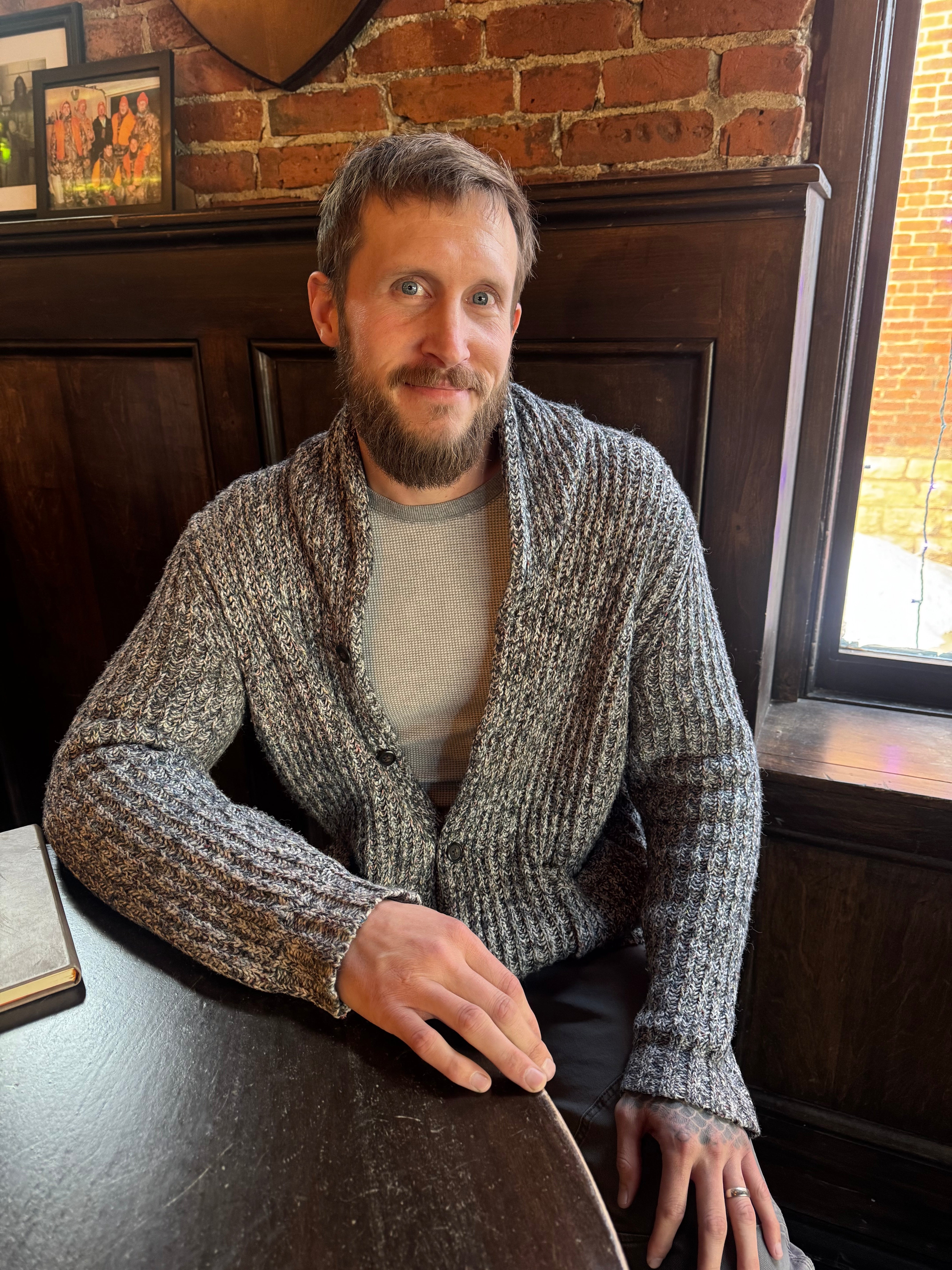 Red Danielson sitting in a cafe with a journal.